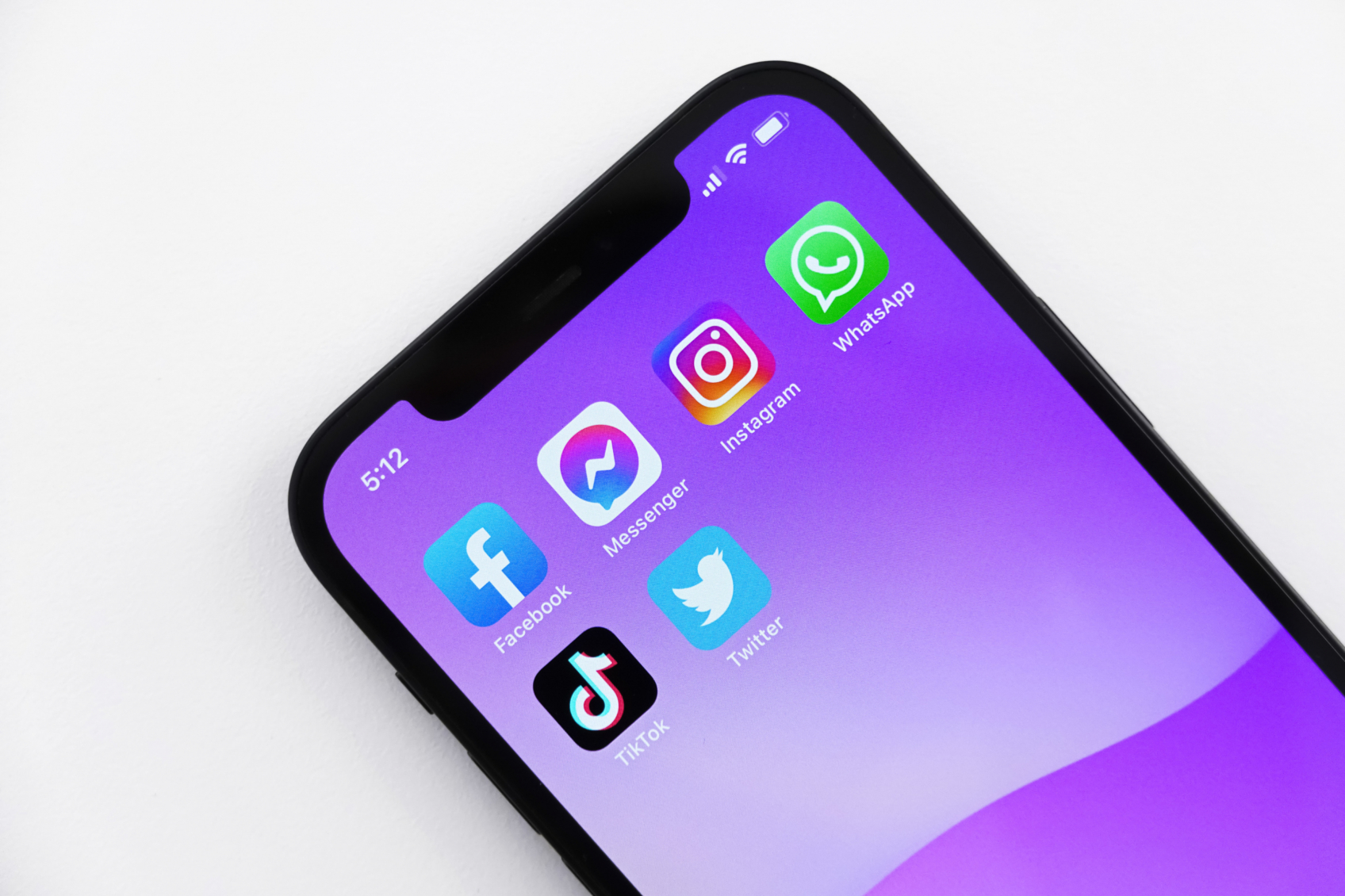 iPhone with Facebook, Messenger, Instagram, WhatsApp, TikTok, and Twitter apps